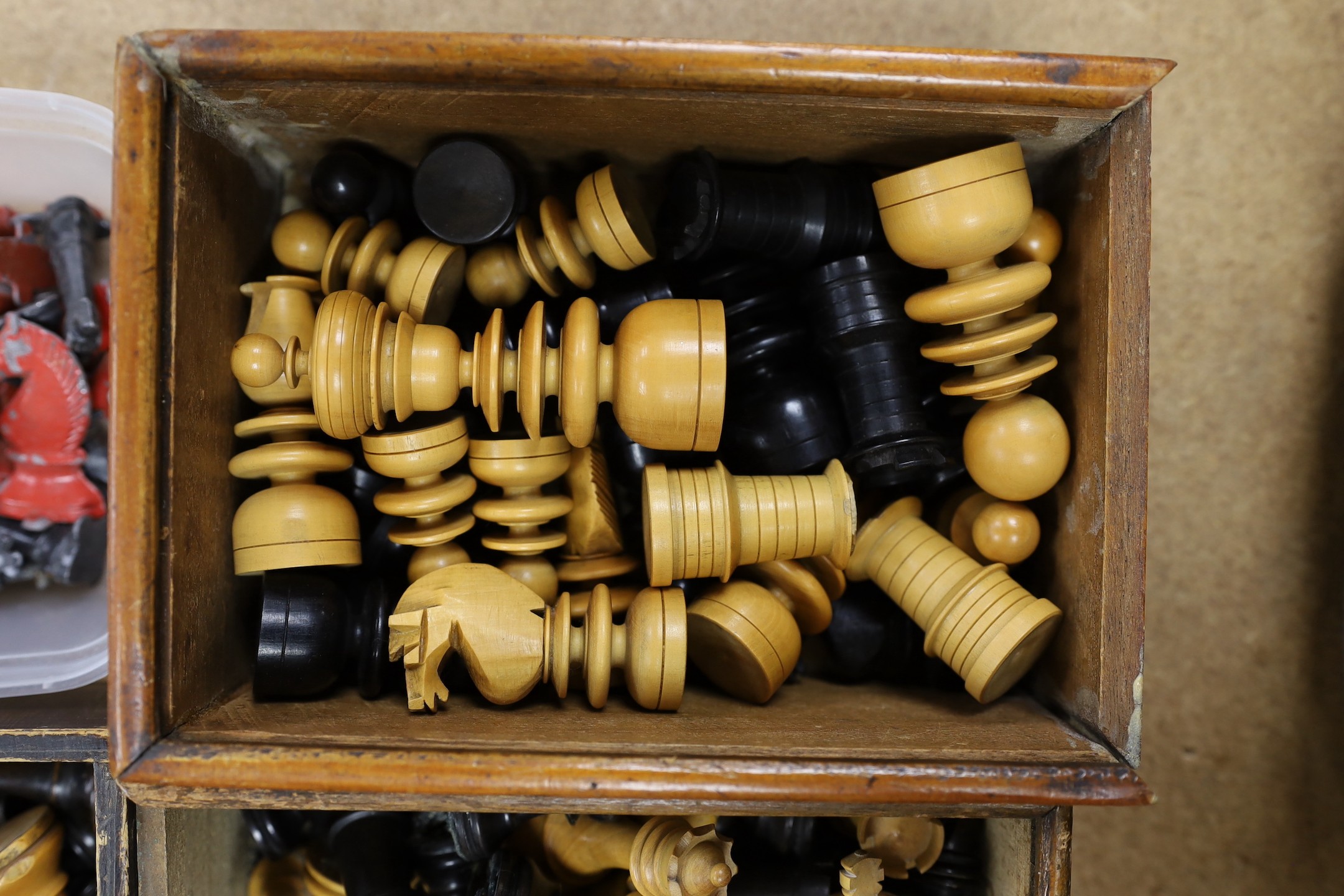 A painted lead chess set together with three boxed turned wooded chess sets.